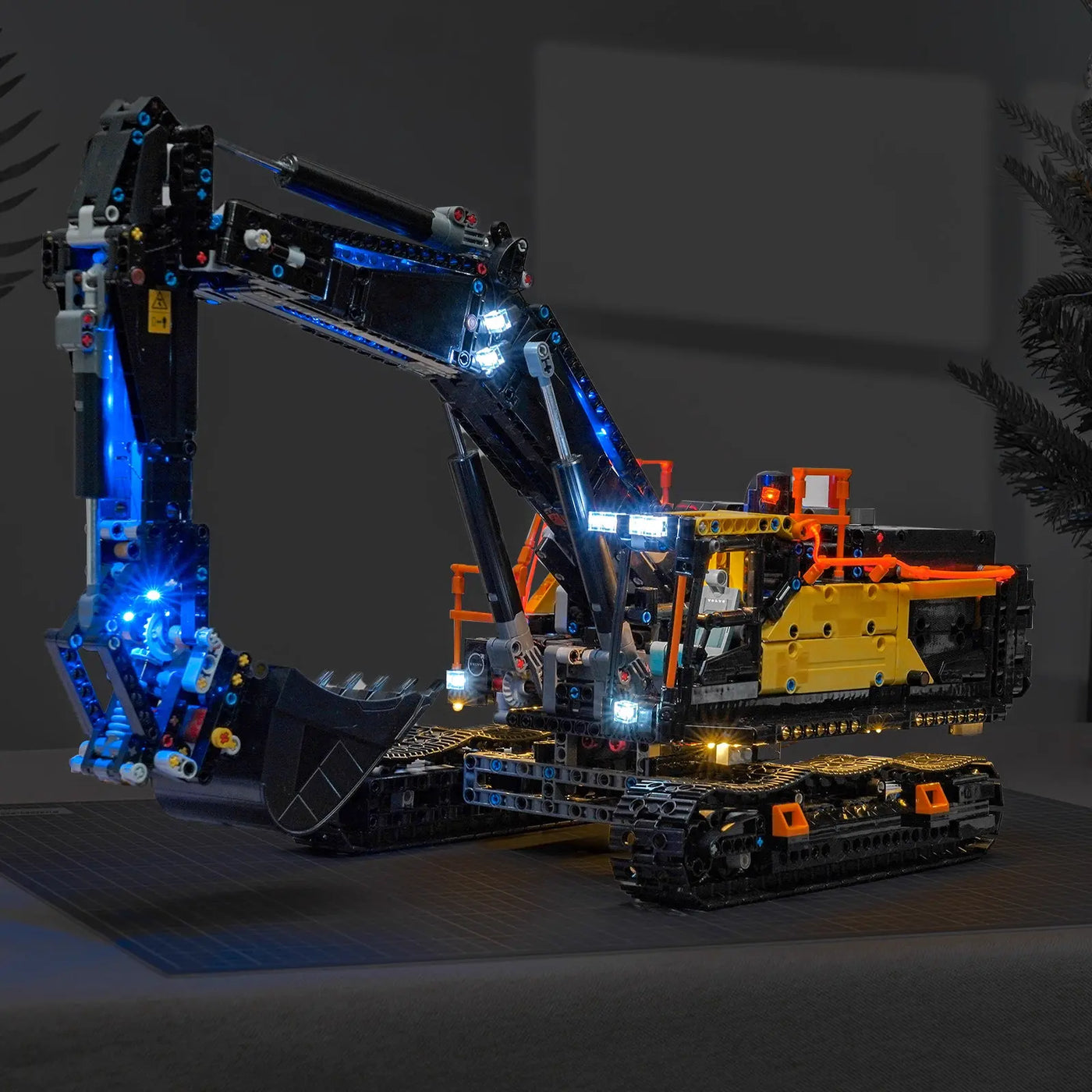 LEGO® Technic Volvo EC500 Hybrid Excavator #42215 illuminated at night, with the LED lighting kit