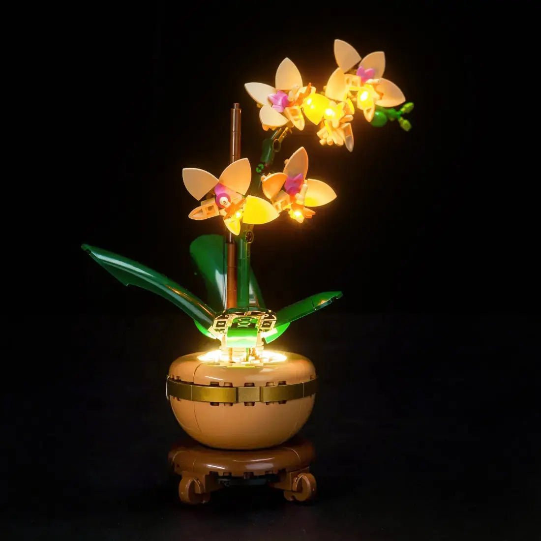 LEGO® The Botanical Collection Mini Orchid #10343 side angle with lights on, with the premium LED light kit
