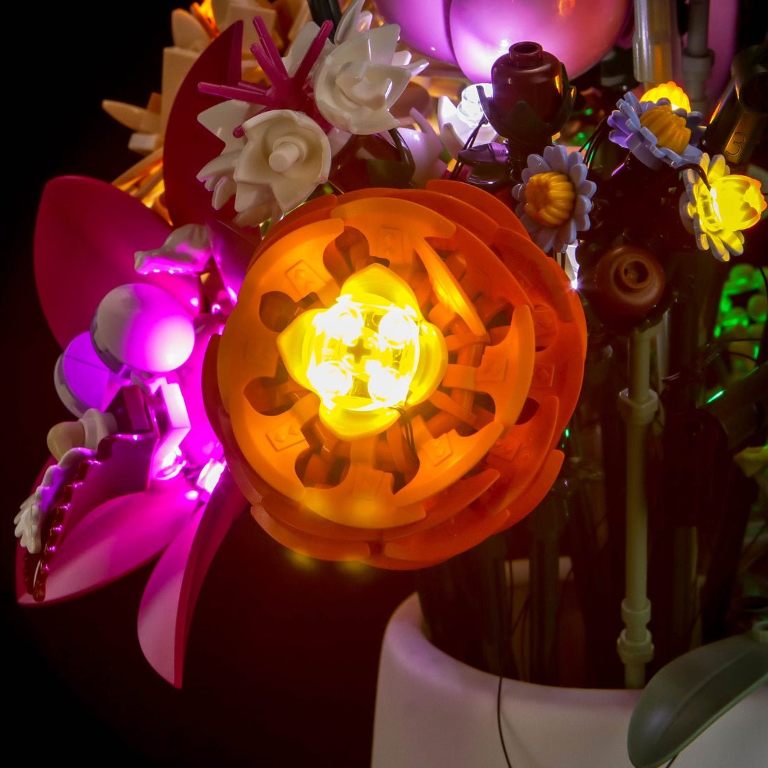 LEGO® The Botanical Collection Pretty Pink Flower Bouquet #10342 side angle with lights on, with the LED lights