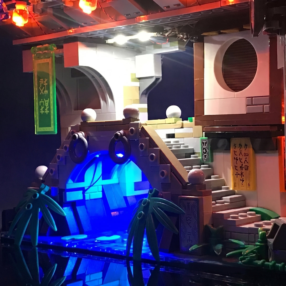 LEGO® The LEGO NINJAGO City #70620 display lighting in a dark room, with the display light kit