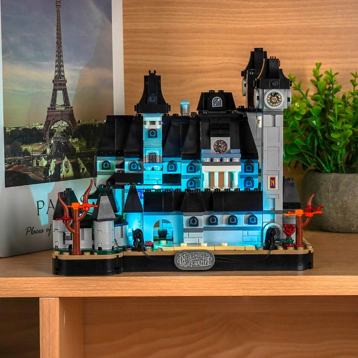 Shelf display of the academy with a cyan façade, white windows and orange trees — LEGO® Nevermore Academy #76788, LED light kit