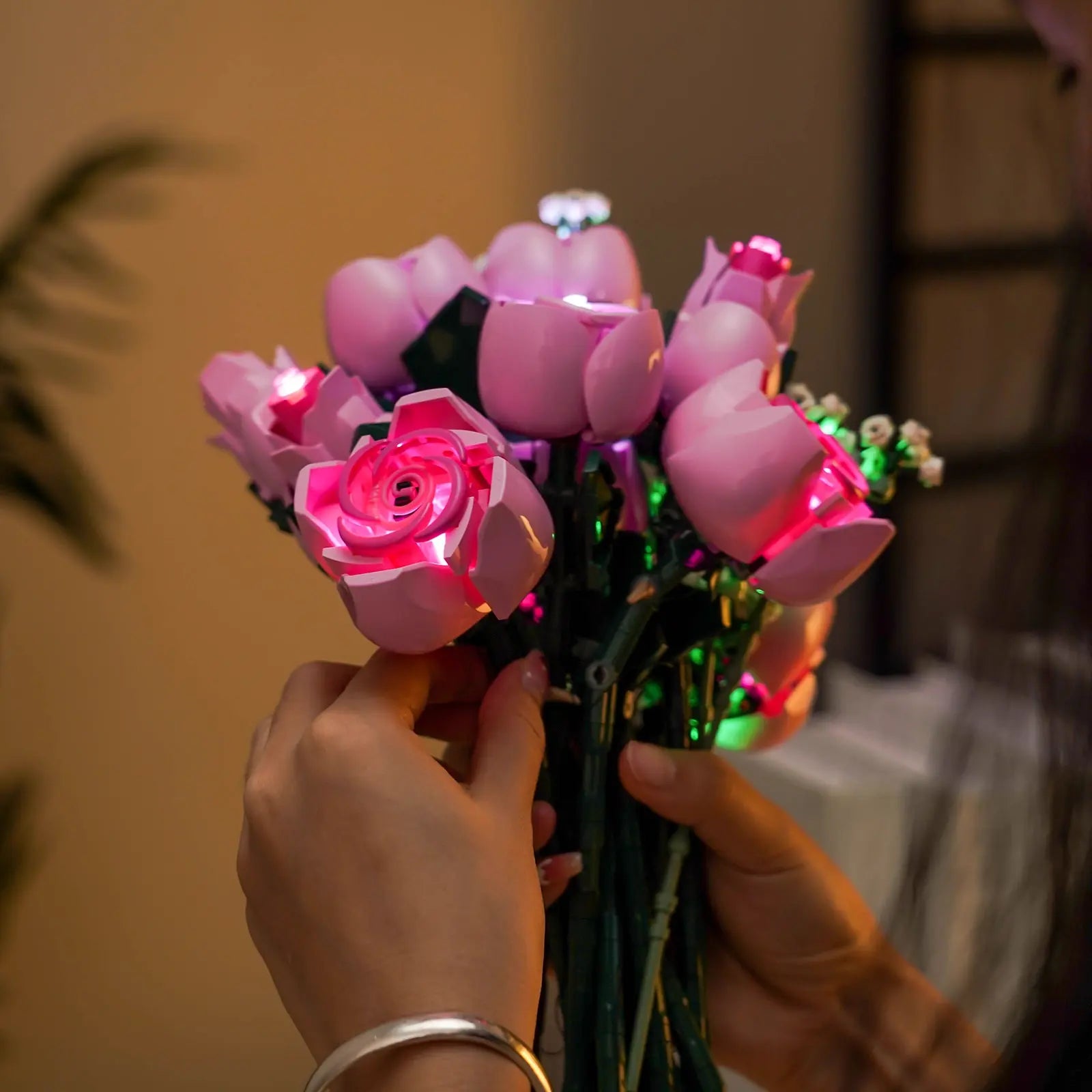 Delicate, tiny LEDs light up the white baby's breath flowers in the LEGO Bouquet of Pink Roses 10374.