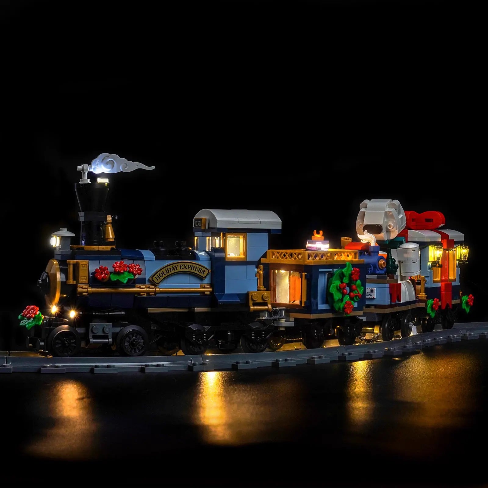 The passenger car of the LEGO Holiday Express Train, with warm interior lights shining through the windows by Bright My Bricks.
