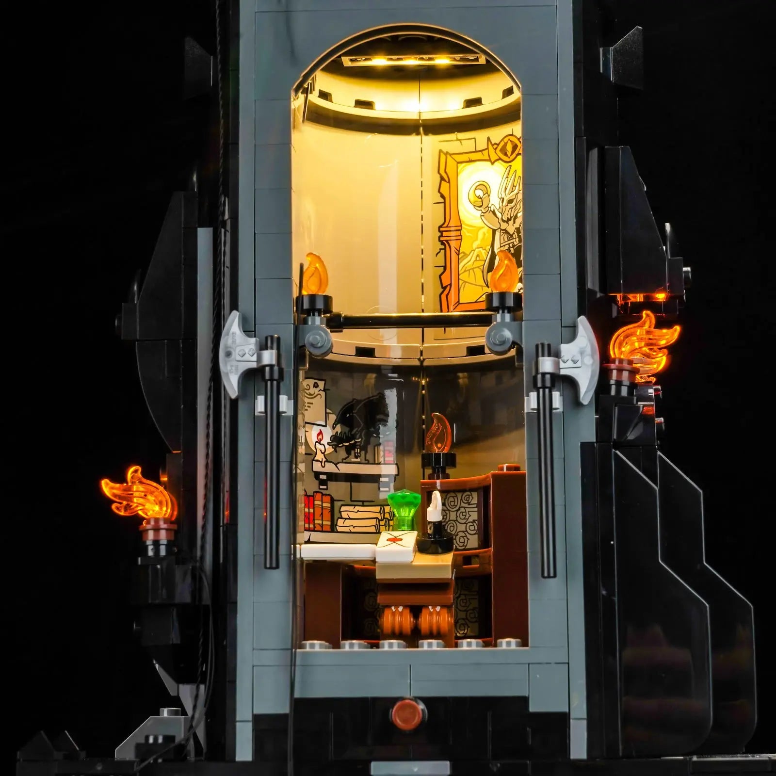 In a darkened room, the illuminated LEGO Barad-dûr 10333 becomes a powerful centerpiece, ruled by the glowing Eye of Sauron.