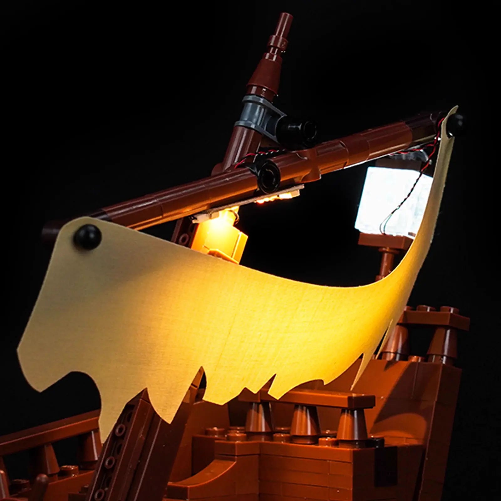 A stunning night display of the fully illuminated LEGO The Goonies 21363, creating a cinematic adventure scene.