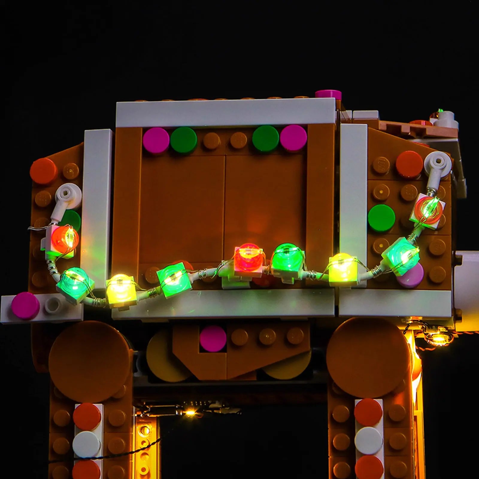 A rear view of the LEGO Gingerbread AT-AT, with festive lights adding a charming glow to the back of the walker.
