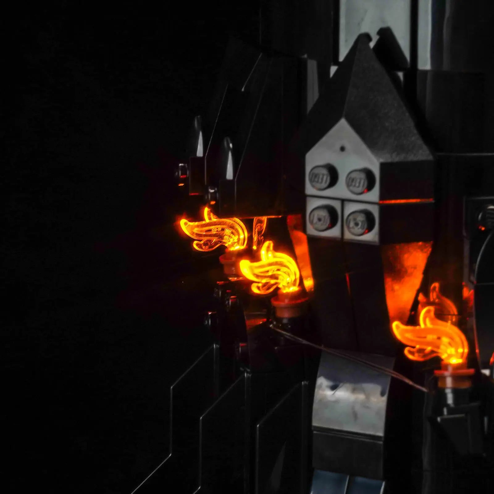 A side profile of the towering LEGO Barad-dûr, showcasing how the seamless lighting enhances its immense height and scale.