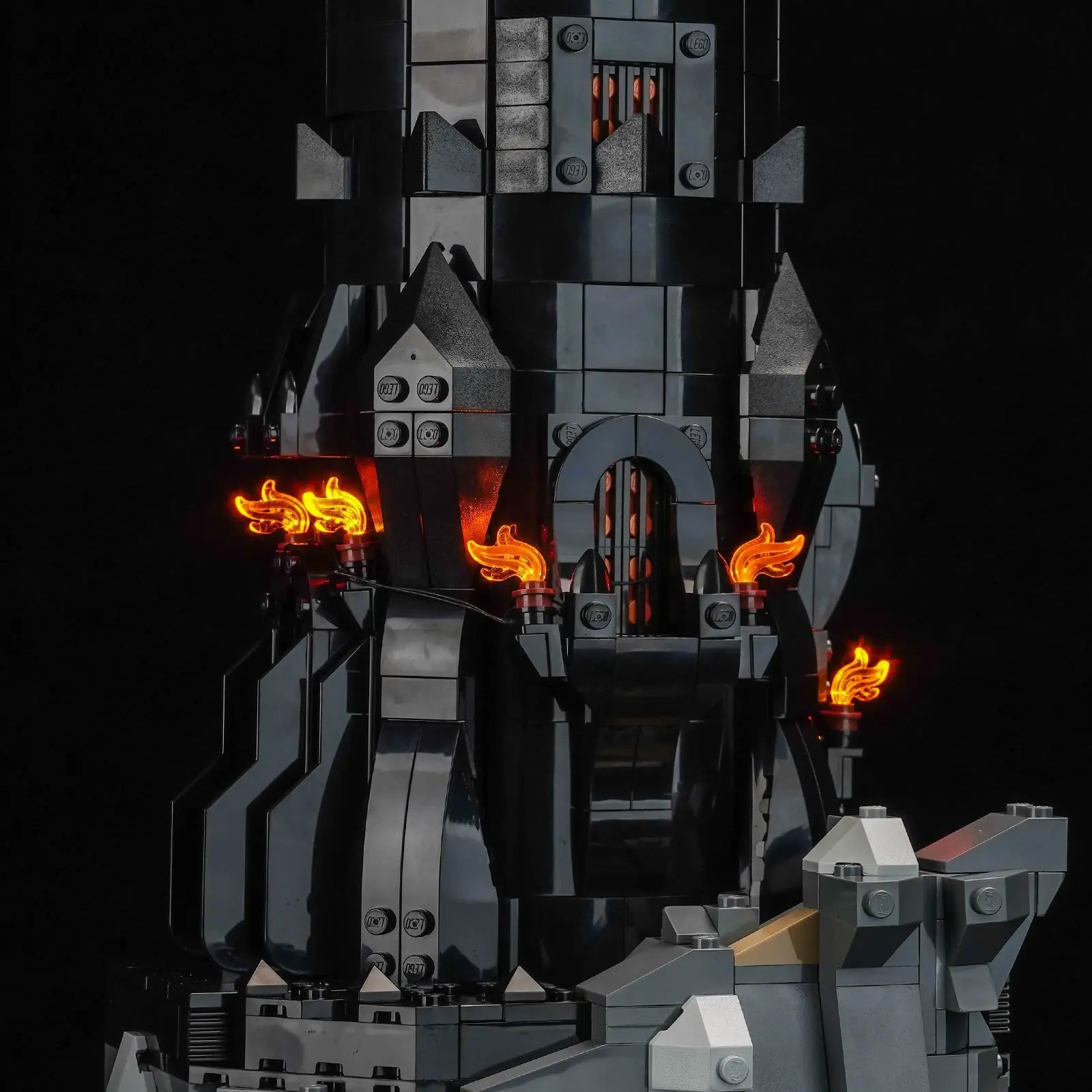 An overhead view looking down past the searching Eye of Sauron, showing the evil glow rising from the tower's depths.