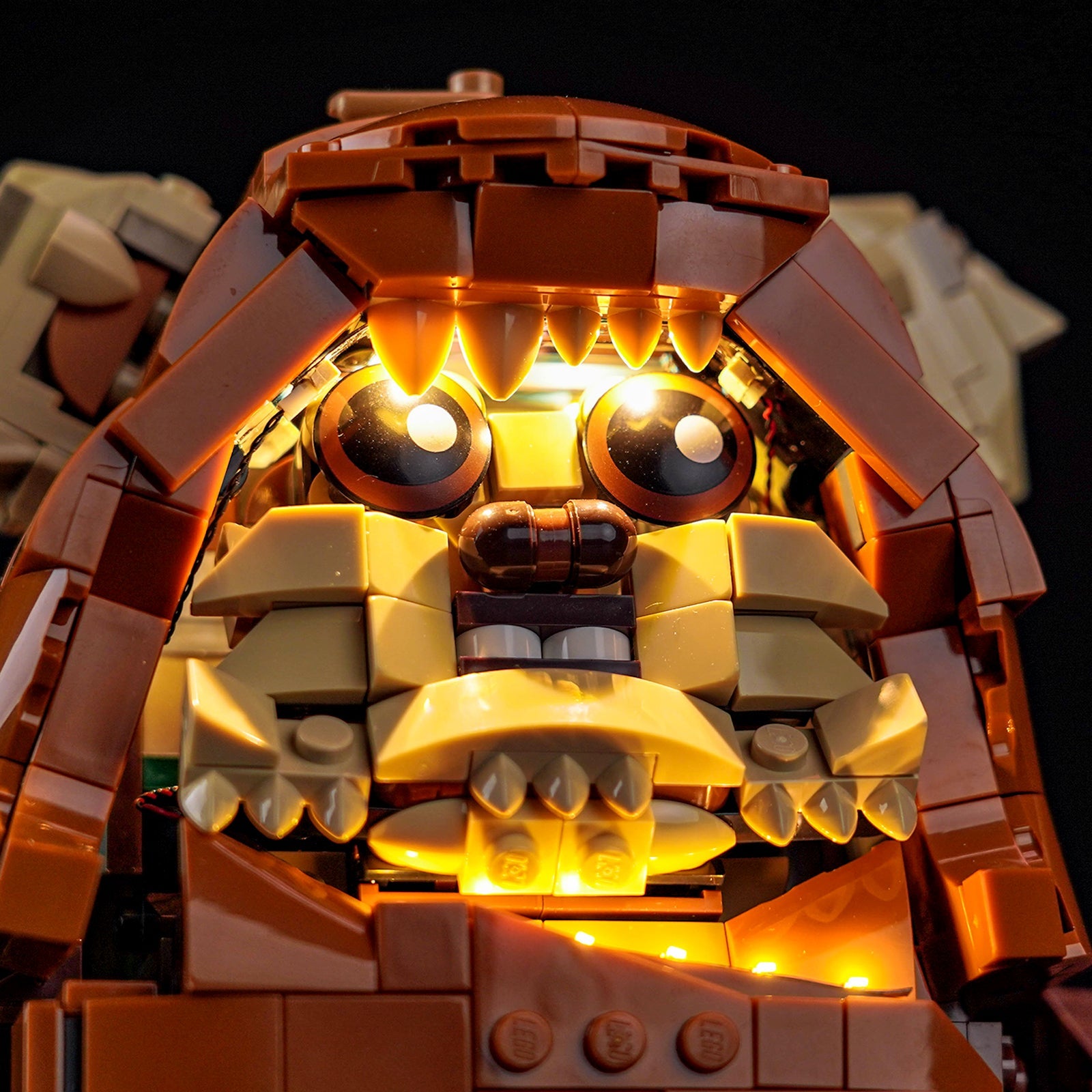 An overhead view of the LEGO Wicket 75430 set, showing the beautifully illuminated details of the forest floor and campfire.