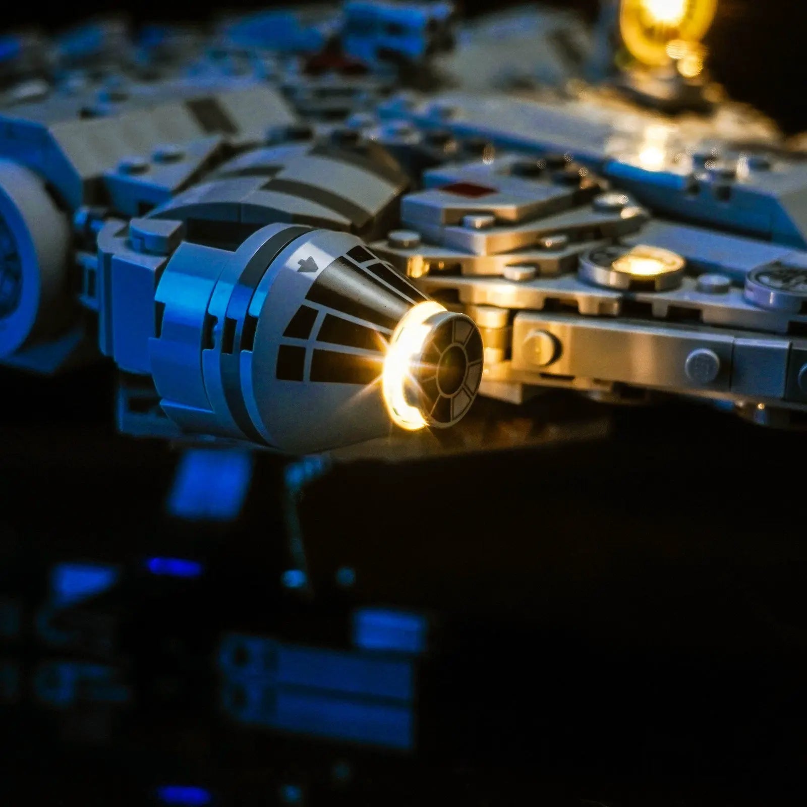 A top-down view of the LEGO Millennium Falcon, highlighting the lights in the mandible pits and dorsal section.