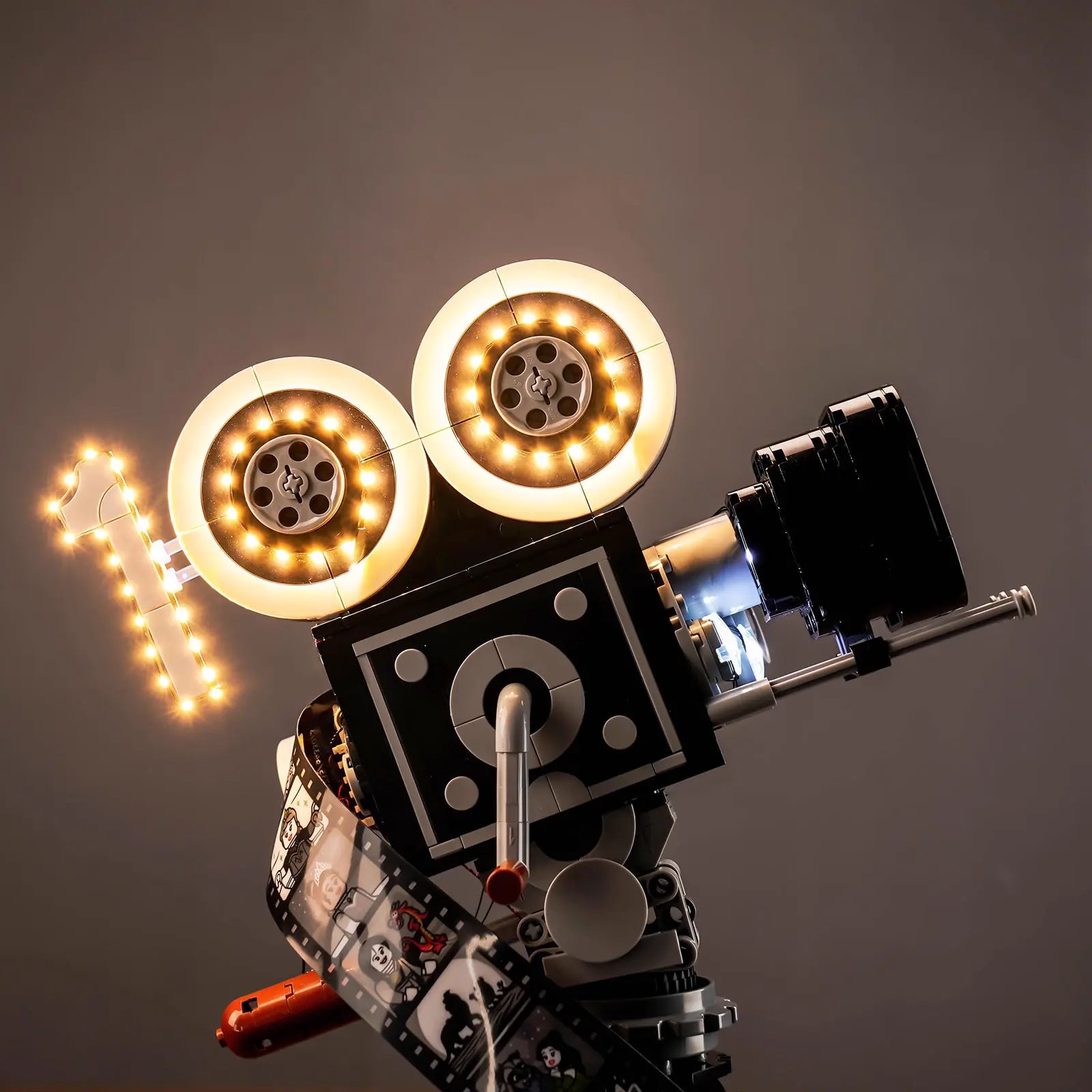 The illuminated LEGO Walt Disney Camera 43230 casts a warm, ambient glow, making it a stunning display piece.